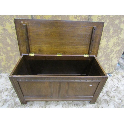 1338 - A reproduction oak coffer with hinged lid and moulded panelled frame, 56cm high x 105cm x 45cm