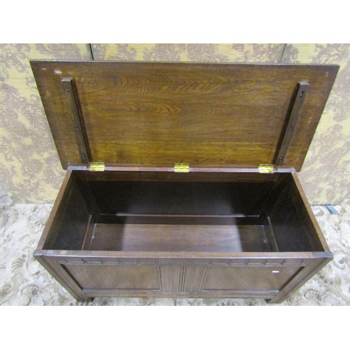 1338 - A reproduction oak coffer with hinged lid and moulded panelled frame, 56cm high x 105cm x 45cm