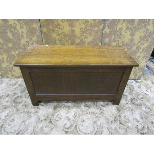 1338 - A reproduction oak coffer with hinged lid and moulded panelled frame, 56cm high x 105cm x 45cm