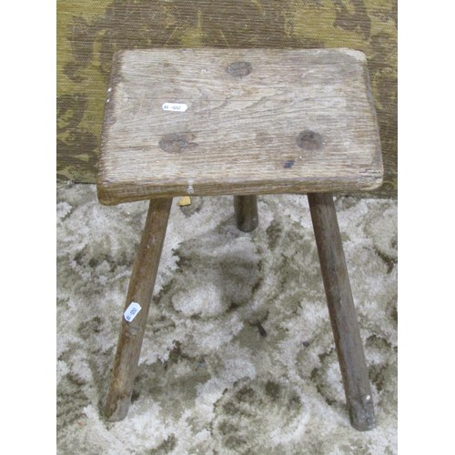 1225 - A rustic country made stool with rectangular seat raised on through jointed splayed legs, 33 cm high... 