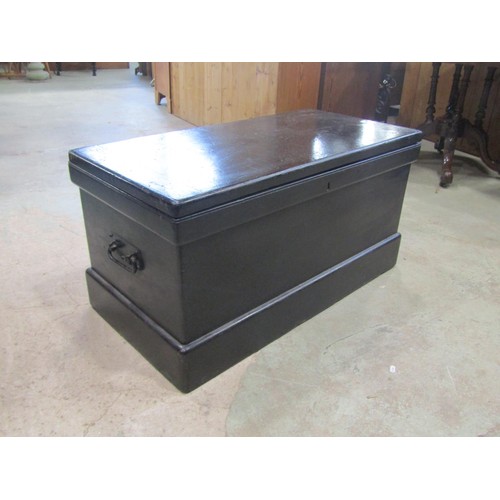 1236 - An antique painted pine chest with hinged lid, segmented interior and drop iron work side carrying h... 