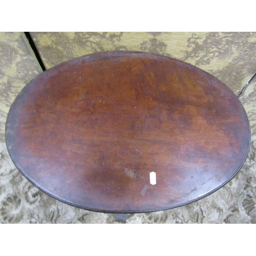 1243 - A 19th century rosewood occasional table with associated oval mahogany top raised on a turned and ca... 