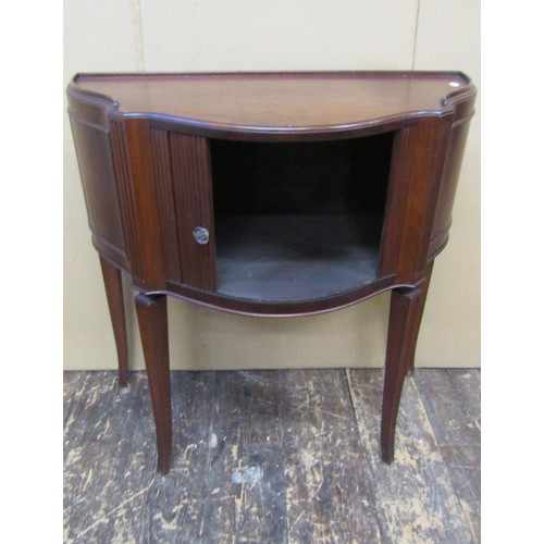 1345 - A mahogany serpentine shaped side or lamp table with tambour front, raised on four swept supports, 7... 