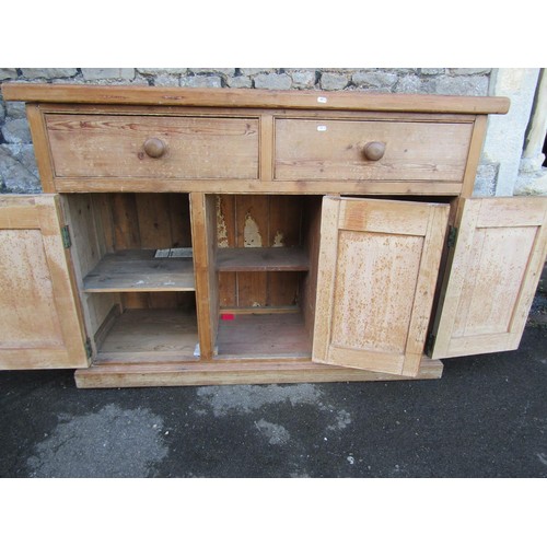 1347 - A stripped and waxed pine kitchen dresser base enclosed by three doors and two frieze drawers, 100cm... 