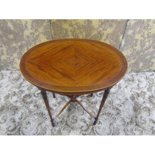 1249 - A good quality inlaid Edwardian mahogany occasional table of oval form raised on four slender turned... 