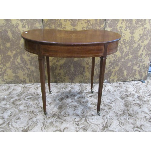 1251 - An inlaid Edwardian mahogany kidney shaped side table with frieze drawer raised on square tapered le... 