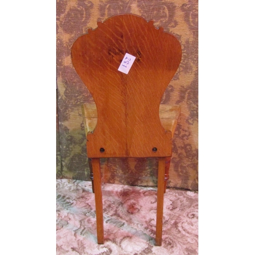 1256 - A Victorian oak hall chair with carved and moulded shield shaped back and raised on turned tapered f... 