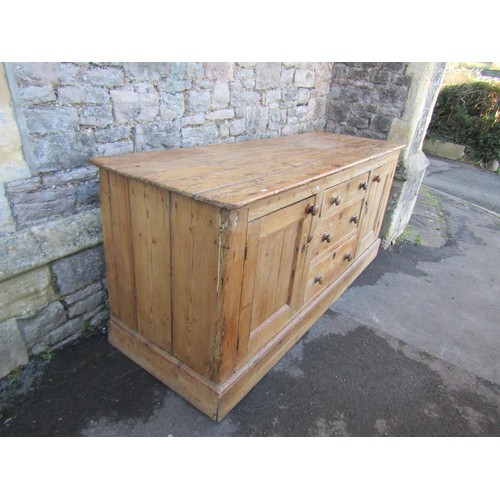 1373 - A substantial Victorian stripped and waxed pine dresser base, partially enclosed by a pair of panell... 