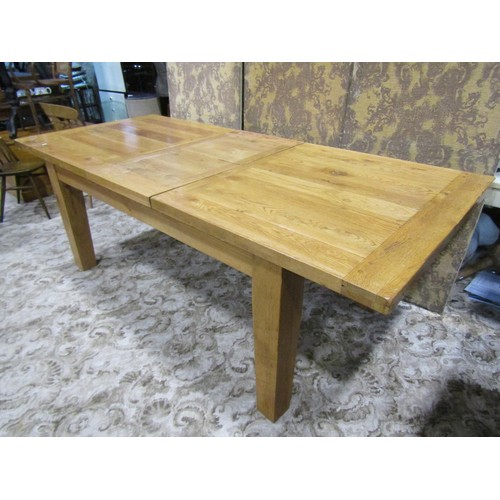 1124 - A contemporary rustic oak extending dining table of rectangular form, with single additional leaf, r... 