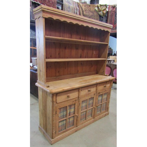 1223 - A stripped pine farmhouse kitchen dresser, the base partially enclosed by three glazed quarter panel... 