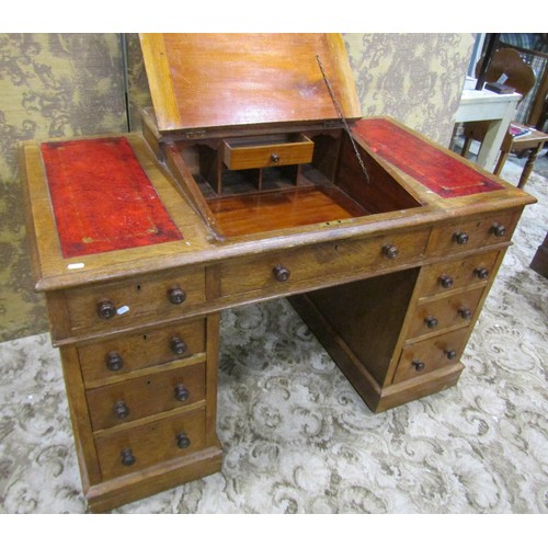 1255 - A Victorian oak Dickens type kneehole twin pedestal desk with inset leather panelled top, over an ar... 