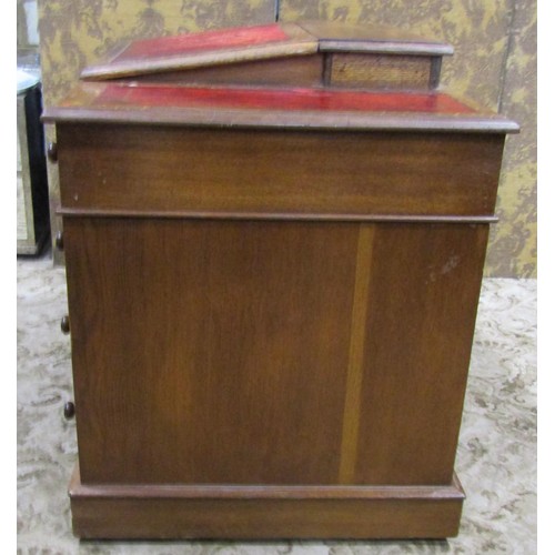 1255 - A Victorian oak Dickens type kneehole twin pedestal desk with inset leather panelled top, over an ar... 