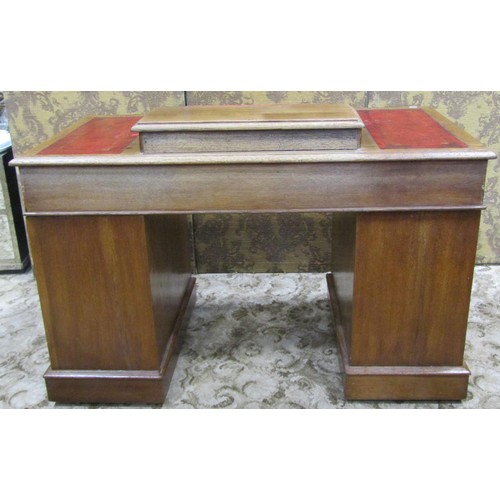 1255 - A Victorian oak Dickens type kneehole twin pedestal desk with inset leather panelled top, over an ar... 