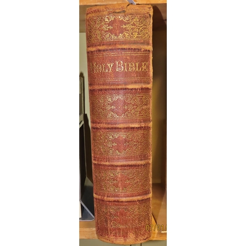 663 - A large Victorian Bible (1868) with brass clasps, maps and multiple engraving illustrations and an u... 