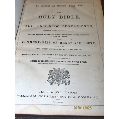 663 - A large Victorian Bible (1868) with brass clasps, maps and multiple engraving illustrations and an u... 