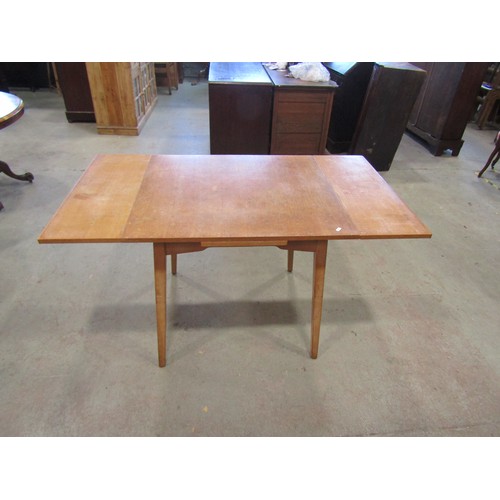 1207 - A vintage 1970's G-Plan draw leaf table, 76cm high x 136cm open, x 76cm together with a set of four ... 