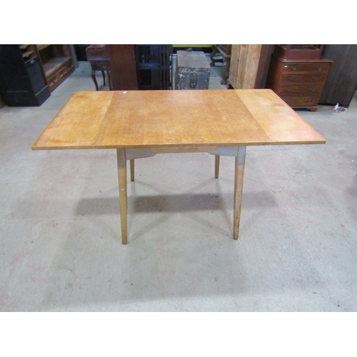 1207 - A vintage 1970's G-Plan draw leaf table, 76cm high x 136cm open, x 76cm together with a set of four ... 