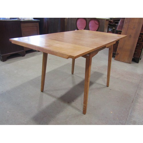 1207 - A vintage 1970's G-Plan draw leaf table, 76cm high x 136cm open, x 76cm together with a set of four ... 