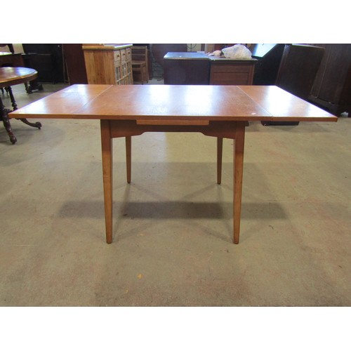 1207 - A vintage 1970's G-Plan draw leaf table, 76cm high x 136cm open, x 76cm together with a set of four ... 