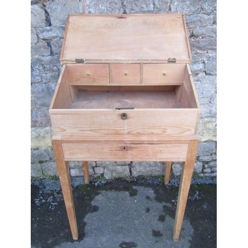 1387 - A 19th century stripped pine clerks desk on square cut supports, together with a stripped  pine box,... 