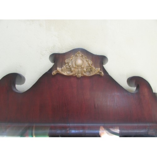 1393 - A large Georgian mahogany wall mirror with shaped outline, enclosing a single mirror plate, 110cm x ... 