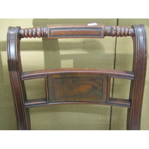 1391 - A  set of four Regency mahogany sabre leg dining chairs with carved cresting rails and drop in seats