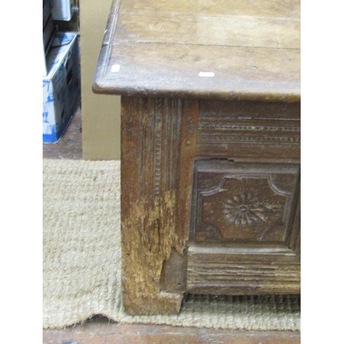 1395 - An early oak paneled coffer, the front elevation enclosing repeating floral detail within moulded st... 