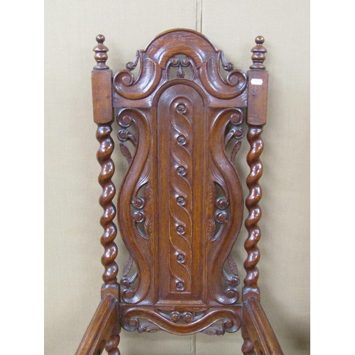 1409 - Two 19th century carved oak hall chairs in a carolean style