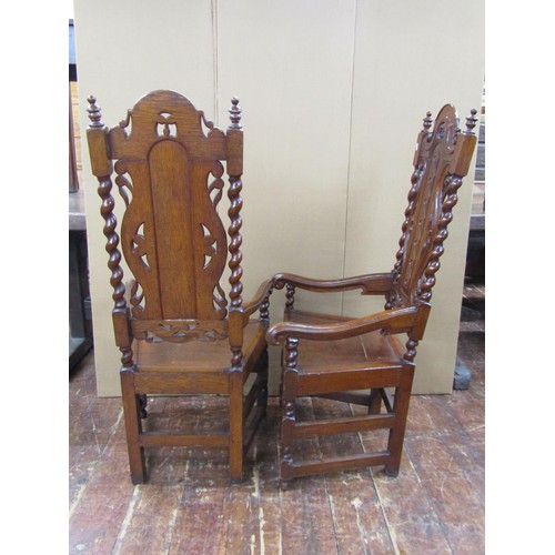 1409 - Two 19th century carved oak hall chairs in a carolean style