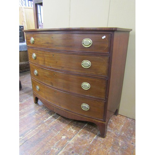 1413 - A Regency mahogany bowfront chest of four long graduated drawers with string banded inlay on four sw... 