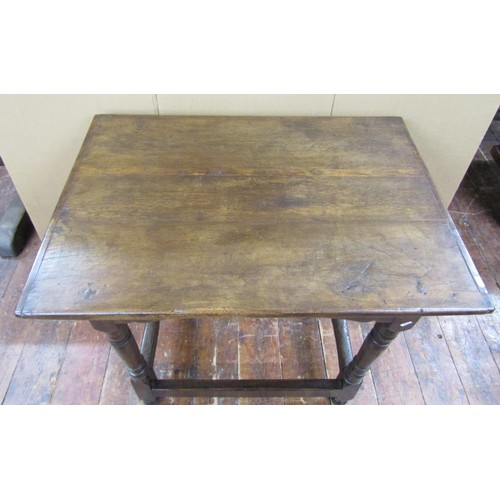 1417 - An old English oak centre table with plank top on turned supports, 95cm x 66cm x 82cm high