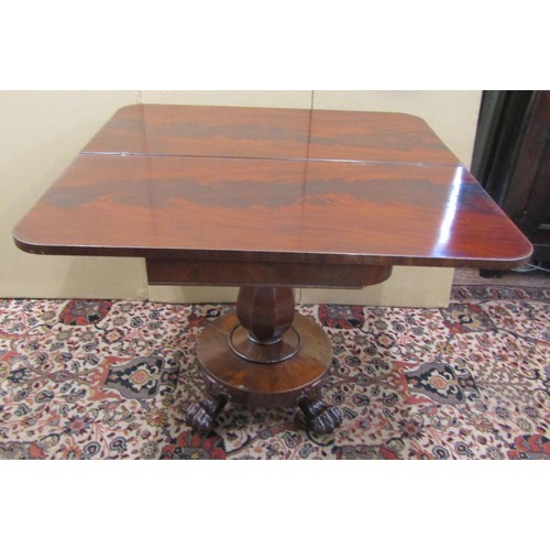 1421 - A Regency mahogany fold over top tea table on an octagonal vase shaped pillar with circular base and... 