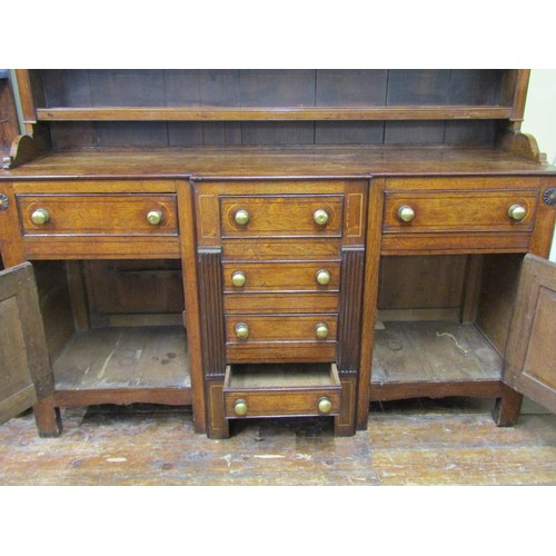 1427 - A Georgian Welsh oak breakfront dresser, the T shaped arrangement of six drawers flanked by two cupb... 