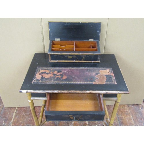 1428 - A Victorian bamboo framed and black lacquered writing desk with raised stationery blocks, 74cm wide