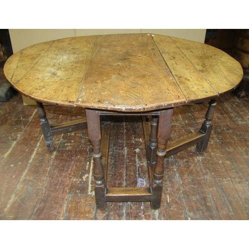 1436 - An 18th century countrymade gateleg table in mixed woods, oak and elm, 119cm long x 45cm when closed... 