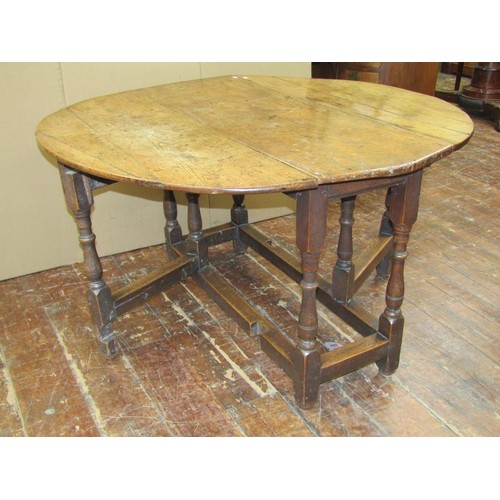 1436 - An 18th century countrymade gateleg table in mixed woods, oak and elm, 119cm long x 45cm when closed... 