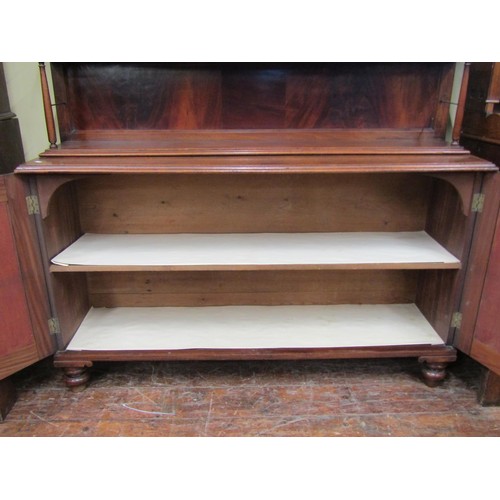 1449 - A Georgian mahogany side cabinet the lower section enclosed by a pair of panelled doors, the upper w... 