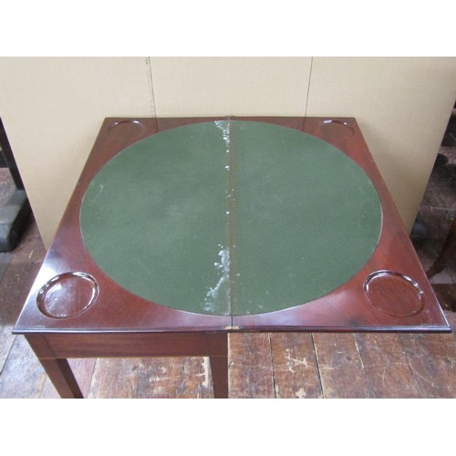 1450 - A Georgian mahogany fold over top card table of rectangular form, the circular baize lined interior ... 