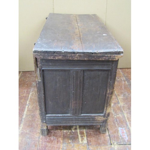 1454 - An 18th century panelled oak coffer the front elevation with geometric carved detail, 66cm high x 10... 