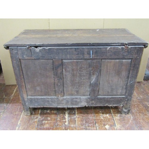 1454 - An 18th century panelled oak coffer the front elevation with geometric carved detail, 66cm high x 10... 