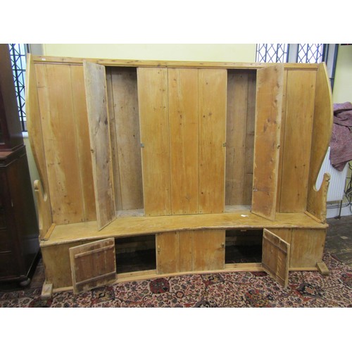 1455 - A very substantial Georgian bacon settle of concave outline, in stripped pine with elm sides and sea... 