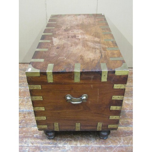 1456 - A 19th century Anglo-Indian hardwood chest with inset brass banding, raised on turned supports, 62cm... 