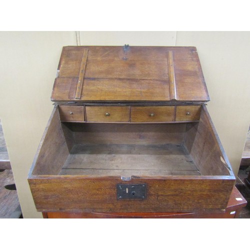 1459 - A 17th century oak writing slope, the rising lid enclosing four small drawers, with steel butterfly ... 