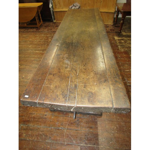 1461 - An early English oak refectory table, the massive top raised on a simple pegged stretcher base, the ... 