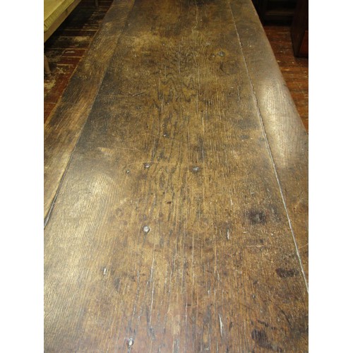 1461 - An early English oak refectory table, the massive top raised on a simple pegged stretcher base, the ... 