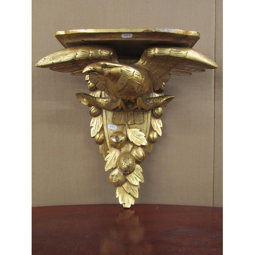 1465 - A 19th century carved oak wall bracket with carved eagle and fruit detail, and later gilded finish, ... 