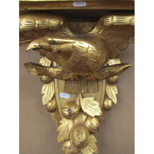 1465 - A 19th century carved oak wall bracket with carved eagle and fruit detail, and later gilded finish, ... 