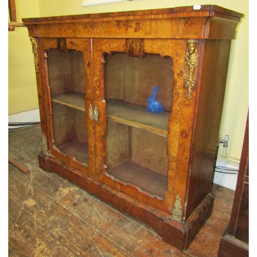 1468 - A Victorian walnut and floral marquetry pier cabinet enclosed by two glazed panelled doors with appl... 