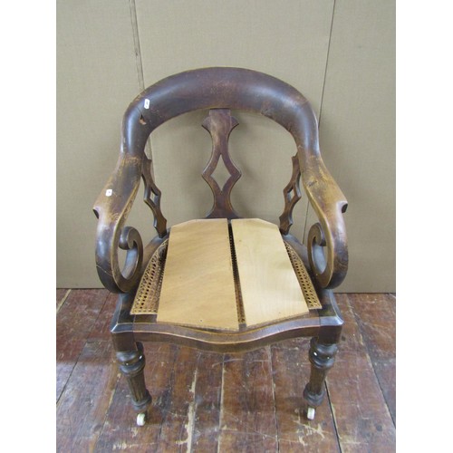 1476 - A Victorian office chair principally in beech wood, on fluted supports, with cane panelled seat (af)