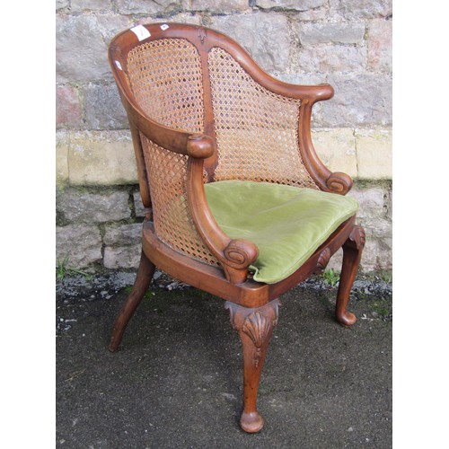 1181A - An Edwardian Bergere chair with horseshoe shaped scrolled back on cabriole supports  (seat for re-co... 